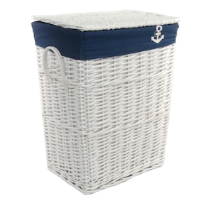 May include: White wicker laundry hamper with a navy blue fabric trim and lid. The lid features a white embroidered anchor. The hamper has a rectangular shape with a woven design and white handles.