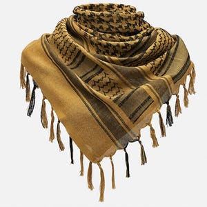 May include: A square scarf featuring a tan and black geometric pattern with a central houndstooth design, bordered by striped and wavy line motifs. The edges are finished with long, thin tan and black tassels hanging from the perimeter.