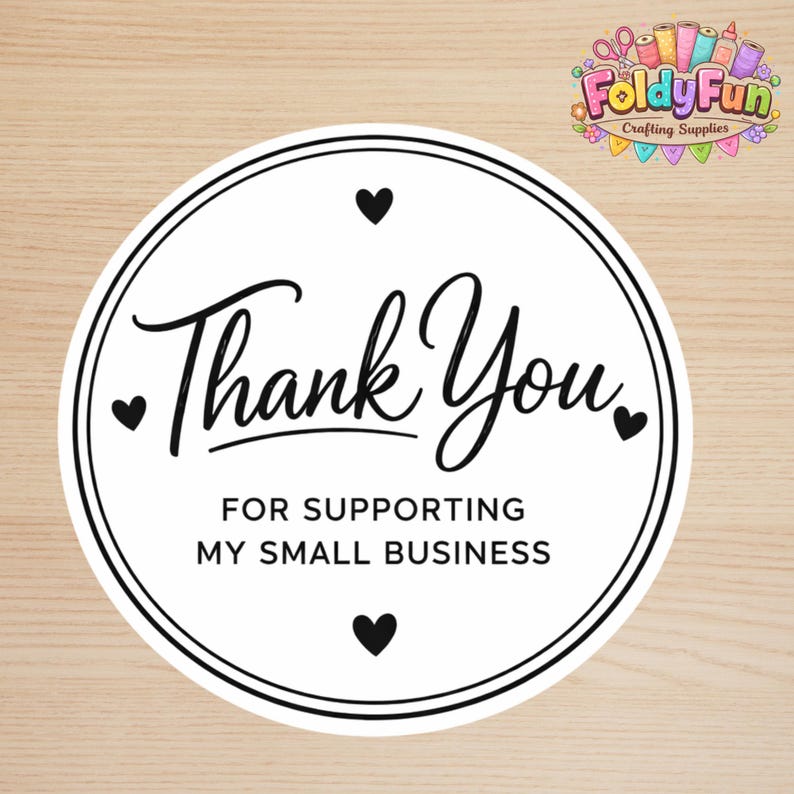May include: A circular white sticker with a black double-line border featuring the text Thank You in a cursive script and FOR SUPPORTING MY SMALL BUSINESS in a sans-serif font, accented by four small black hearts positioned around the text.