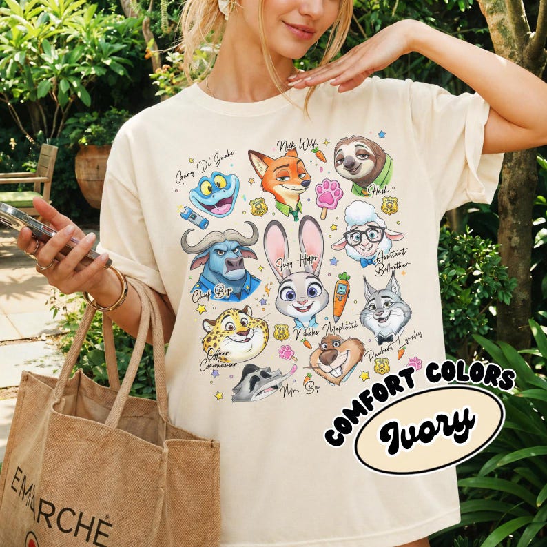 Ivory cream Zootopia character shirt in a retro 90s style. This neutral-toned Comfort Colors tee features a large collage of Judy, Nick, and the ZPD crew with playful hand-drawn accents. Perfect for a minimalist Disney park look or a cottagecore aesthetic. The soft ivory fabric pairs beautifully with the vibrant character colors. Worn by a model with a burlap tote bag in a lush garden setting. A high-quality, breathable cotton shirt that makes a thoughtful gift for movie lovers and fans.