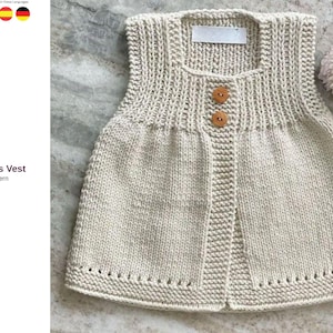 May include: A cream-colored knitted vest with two wooden buttons. The vest has a ribbed neckline and a decorative bottom edge. The text "Timeless Vest" and "Knit Pattern" are visible on the left side of the image.