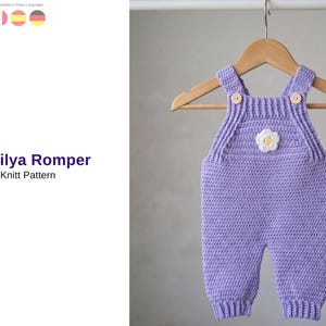 May include: A lavender knitted baby romper with a white flower applique, hanging on a wooden hanger. The romper has button closures on the straps and ribbed detailing. The text "Sicilya Romper Knitt Pattern" is visible.