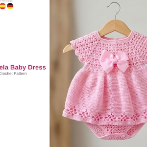 May include: A handmade pink crochet baby dress with a matching bow. The dress is displayed on a wooden hanger. The text "Sundrela Baby Dress Crochet Pattern" is visible on the left side of the image.