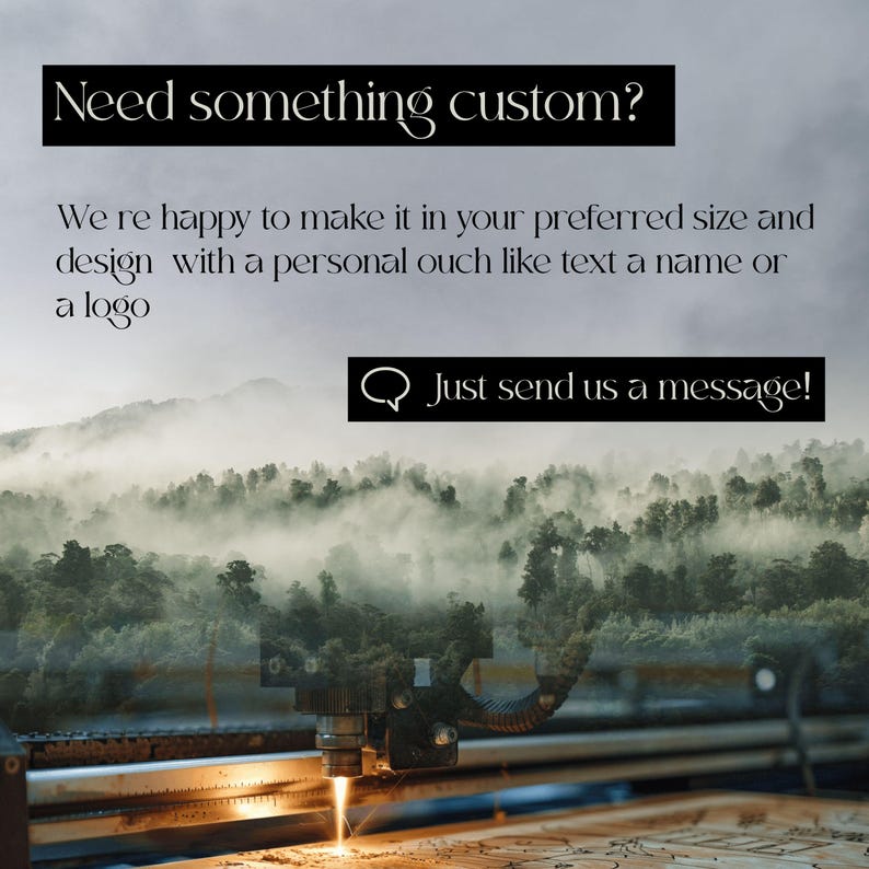 May include: Image featuring a laser cutter in operation, with text overlay: "Need something custom?" and "Just send us a message!". The background shows a misty forest scene. The text encourages custom orders.