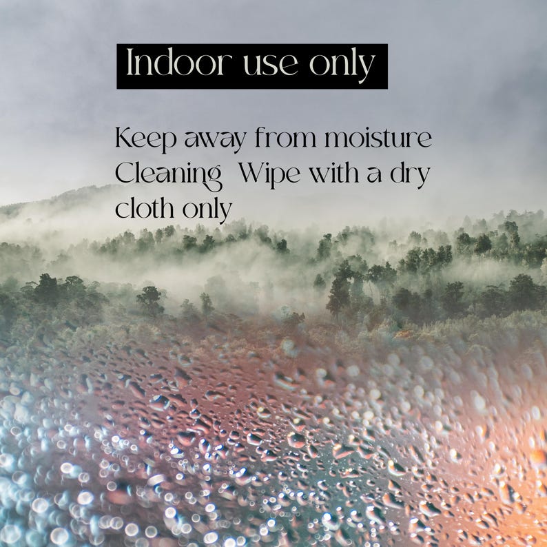 May include: Image with text: "Indoor use only. Keep away from moisture. Cleaning: Wipe with a dry cloth only." The background shows a misty forest with water droplets on the foreground.