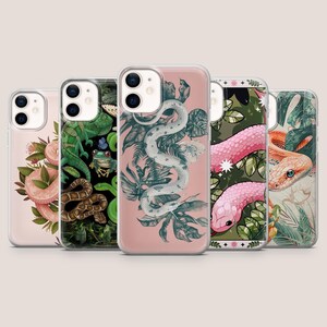 May include: A collection of five phone cases with unique designs. The cases feature illustrations of snakes, flowers, and foliage in various colors, including pink, green, and white. Each case has a clear border.