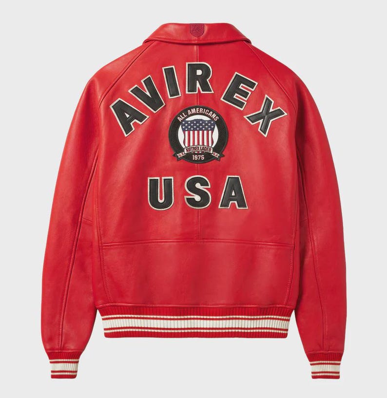 May include: A red leather jacket with the word "AVIREX" arched across the shoulders in white lettering with a black outline. Below the word "AVIREX" is a circular patch with the words "ALL AMERICANS" and "1975". The word "USA" is below the patch.