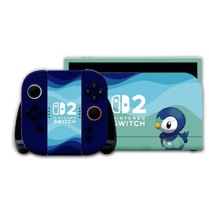 Op de afbeelding: Een Nintendo Switch console en controller set met een blauw en turquoise golfontwerp. De console heeft de tekst "Nintendo Switch" en een afbeelding van een pinguïn. De controller is donkerblauw met zwarte knoppen.