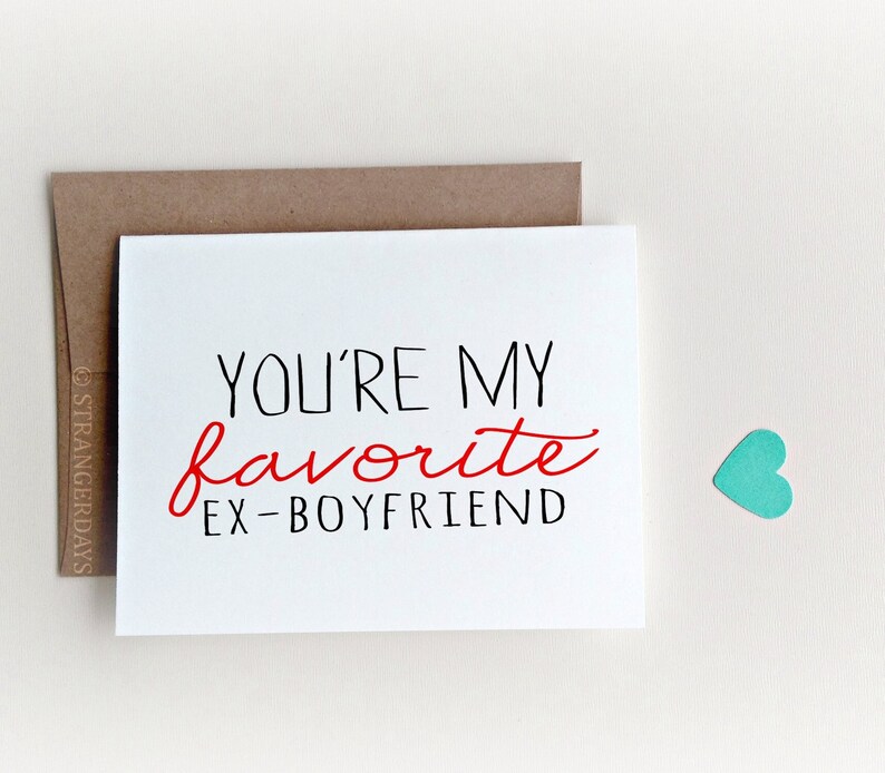 May include: A white greeting card with the text "YOU'RE MY favorite EX-BOYFRIEND" in black and red lettering. A brown envelope is behind the card, and a small teal heart is to the right. The card is a humorous gift.