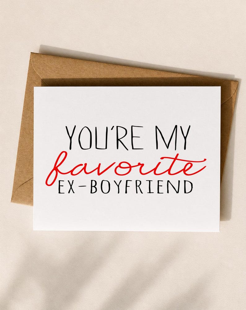 May include: A white greeting card with the text "YOU'RE MY favorite EX-BOYFRIEND" in black and red font, placed on top of a brown envelope. The card is square-shaped and the font is a mix of serif and script.