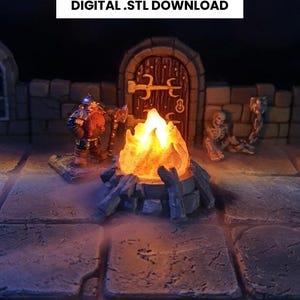 May include: A miniature diorama scene featuring a campfire with a bright orange glow, surrounded by stone and a dwarf figure. The text "WAYFARER'S CAMPFIRE" and "DIGITAL .STL DOWNLOAD" are displayed above the scene.