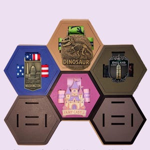 May include: A collection of magnetic, modular, and modern hexagon-shaped display pieces. Each piece features a different design, including a dinosaur, a fairy castle, and a Washington D.C. monument. The text "Magnetic", "Modular", and "Modern" is displayed at the bottom.