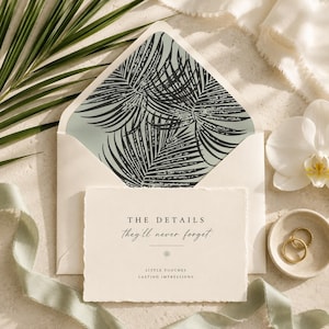May include: A cream-colored rectangular card with deckled edges featuring the black text THE DETAILS they'll never forget. LITTLE TOUCHES. LASTING IMPRESSIONS. It sits inside an open envelope with a sage green interior and a black palm leaf pattern.