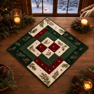 May include: A square quilted table topper featuring a geometric pattern of cream, deep red, and dark green fabric squares. The design includes printed motifs of pine branches, red berries, and gold stars, with visible stitching throughout the fabric.