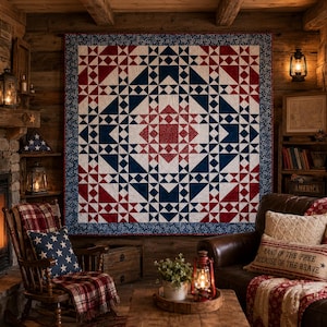 May include: A large square quilt featuring a geometric star pattern in red, white, and navy blue. The quilt has a central red block surrounded by intricate triangular and square shapes, finished with a dark blue floral border and red binding.
