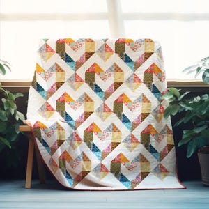 May include: A colourful patchwork quilt with a geometric design, featuring shades of blue, orange, yellow, and green. The quilt is displayed over a wooden bench, highlighting its intricate pattern and craftsmanship.