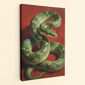 May include: A rectangular canvas wall art print featuring a coiled green snake with detailed scales against a solid deep red background. The snake is positioned in an S-shape with its head raised and a small portion of its tongue visible.