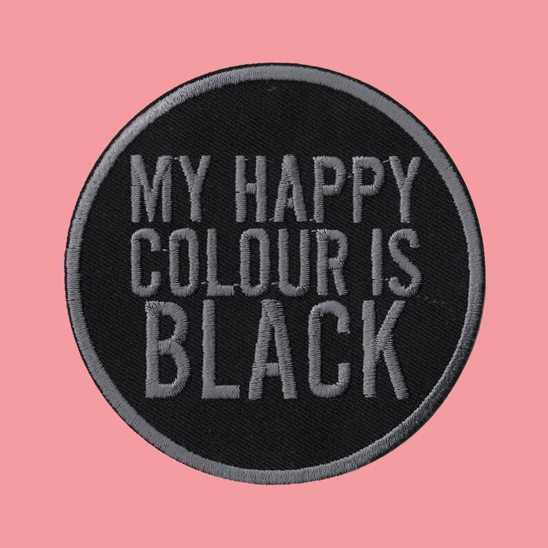 May include: Black and grey embroidered patch with the text "My happy colour is black".