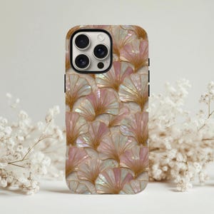 May include: A smartphone case featuring a repeating pattern of fan-shaped ginkgo leaves. The leaves have a pearlescent, iridescent finish in shades of soft pink and cream, accented with fine gold-colored lines that define the leaf veins.