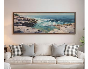 May include: A panoramic landscape painting in a dark wood frame depicting a rocky coastline with crashing blue and turquoise ocean waves. The scene features jagged light-colored rocks along the shore meeting the sea under a clear horizon line.