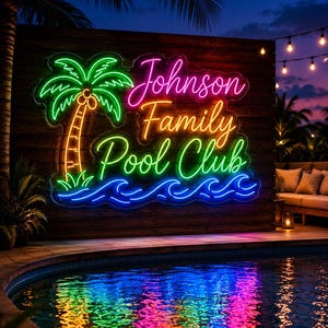 May include: A neon sign mounted on a wooden wall featuring a green palm tree, blue ocean waves, and the text Johnson Family Pool Club in pink, orange, and green script lettering. The sign is illuminated above a swimming pool at night.