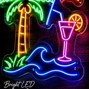 May include: A multi-colored LED neon sign featuring a green palm tree with an orange trunk, a blue ocean wave, and a pink cocktail glass with an orange slice garnish. The sign includes a red umbrella and the text Bright LED Neon Glow.