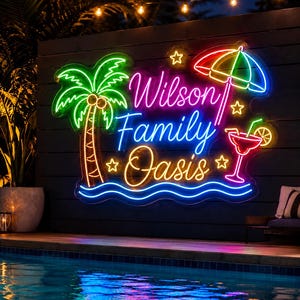 May include: A multi-colored neon sign featuring the text Wilson Family Oasis in script and print lettering. The sign includes a green palm tree, a red and blue beach umbrella, a red cocktail glass with a slice of fruit, and yellow stars.