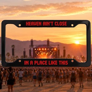 May include: A black rectangular license plate frame with rounded corners and four mounting holes. The top bar features the red text HEAVEN AIN'T CLOSE and the bottom bar features the red text IN A PLACE LIKE THIS in a pixelated font style.
