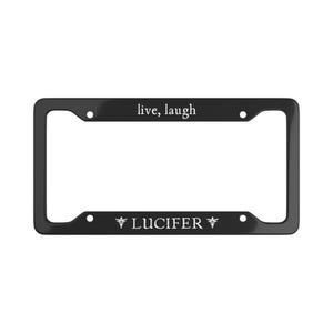 Può includere: Cornice nera per targa con le parole "live, laugh" in alto e "LUCIFER" in basso. Il testo è bianco e la cornice ha una finitura lucida.