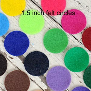 May include: Assortment of 1.5 inch felt circles in various colors, including blue, green, red, yellow, purple, brown, and black.  The felt circles are arranged in rows on a white wooden surface.