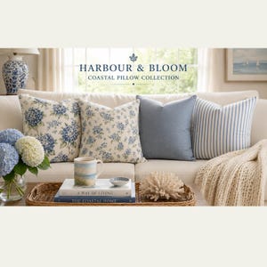 May include: Four square throw pillows arranged on a sofa, featuring two floral patterns with blue hydrangeas, one solid blue, and one blue and white striped pillow. Text reads HARBOUR & BLOOM COASTAL PILLOW COLLECTION above the pillows.
