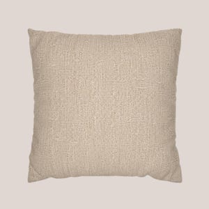 May include: A square throw pillow featuring a solid light beige color and a prominent, coarse woven fabric texture. The pillow has a simple, clean-edged design with a visible grid-like weave pattern throughout the entire surface of the cover.