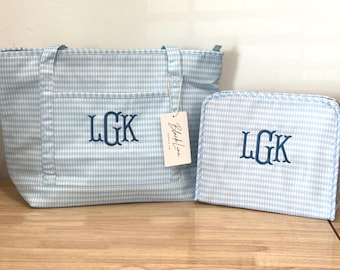 May include: A light blue and white gingham tote bag and a matching rectangular pouch, both featuring the embroidered navy blue monogram LGK. A white rectangular tag with the text Black Line Supply Co is attached to the tote bag handle.