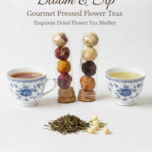 May include: An image showcasing gourmet pressed flower teas. Two clear tubes display colorful dried flower tea balls. Two teacups with blue floral patterns hold tea. Loose tea leaves and flowers are also present.
