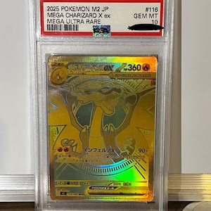May include: A gold Mega Charizard X ex Pokemon card, graded GEM MT 10, encased in a protective holder. The card features Japanese text and a holographic design. The card is from the 2025 Pokemon M2 JP set, Mega Ultra Rare.