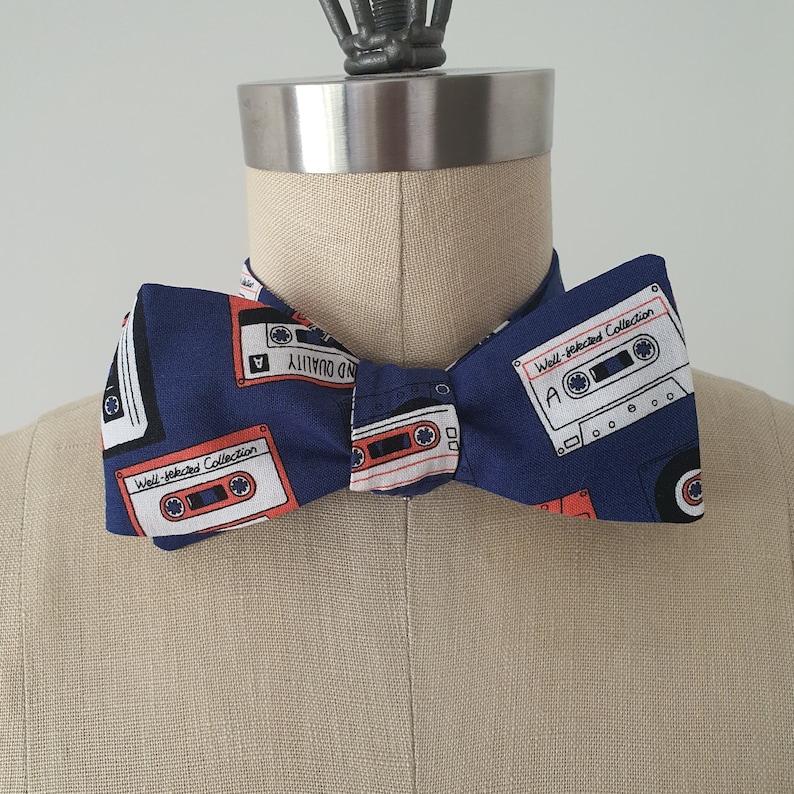 Self-tie and pre-tie bow tie cassette tapes on deep blue retro print*