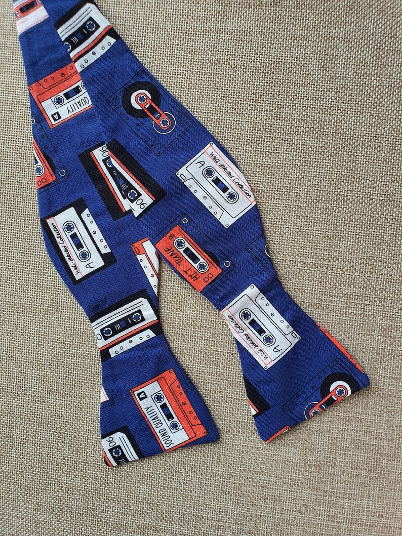 Self-tie and pre-tie bow tie cassette tapes on deep blue retro print*