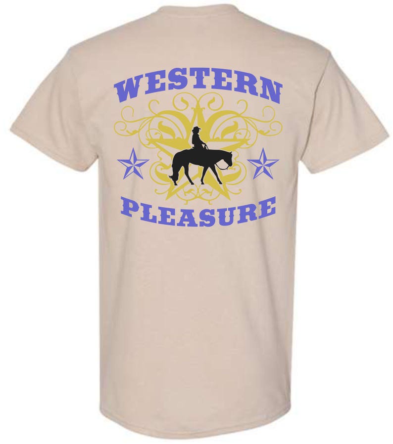 May include: Tan t-shirt with a Western-themed design. The back of the shirt features the words "WESTERN PLEASURE" in blue, with a silhouette of a rider on a horse, a yellow star, and blue stars.