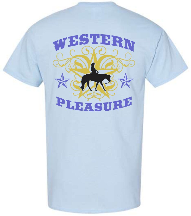 May include: Light blue t-shirt with a graphic design featuring a silhouette of a rider on a horse, a yellow star, and the words "WESTERN PLEASURE" in purple. The design includes two purple stars and decorative swirls.