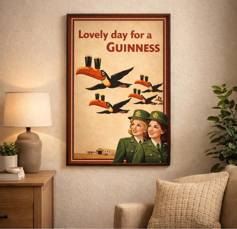 May include: A framed vintage-style Guinness advertisement. The artwork features toucans carrying pints of Guinness, with the text "Lovely day for a Guinness." Two women in green uniforms are also depicted.