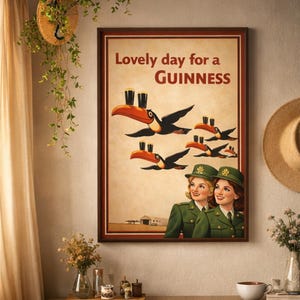 May include: Framed print with the text "Lovely day for a Guinness." The artwork features toucans carrying pints of Guinness, with two women in green uniforms below. The background is a light tan color.