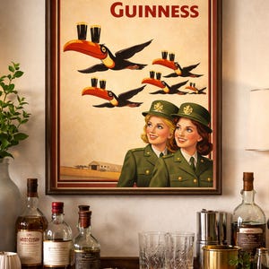 May include: Framed vintage-style Guinness advertisement featuring toucans carrying pints of Guinness. The poster has the text "Lovely day for a Guinness" and depicts two women in green uniforms. The image is displayed on a wooden surface with bottles and glasses.