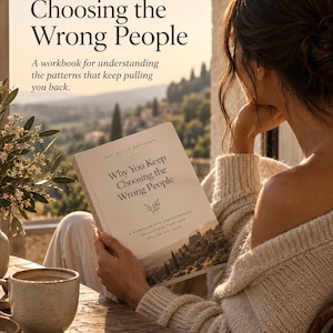 May include: A softcover workbook titled Why You Keep Choosing the Wrong People by The Quiet Between. The cover features a landscape illustration of a hillside town, a small sprig graphic, and the subtitle A workbook for understanding the patterns that keep pulling you back.