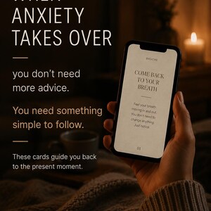 May include: A smartphone displaying text that reads: BREATHE, COME BACK TO YOUR BREATH, Feel your breath moving in and out. You don't need to change anything. Just notice. 01. The screen is held against a dark background with text overlay.