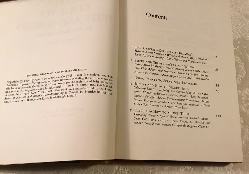 May include: A book cover with the title "The Home Gardener's Guide to Trees and Shrubs" and a table of contents listing the chapters: "The Garden - Delight or Dilemma?", "Trees and Shrubs - What and Where", "Using Plants to Solve Site Problems", "Shrubs and How to Select Them", and "Trees and How to Select Them".