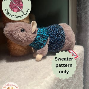 May include: A plush toy rat wearing a blue and black crocheted sweater. The image includes text that reads "Crochet Pattern Digital Download" and "Sweater pattern only". A logo with a dog is in the lower left corner.