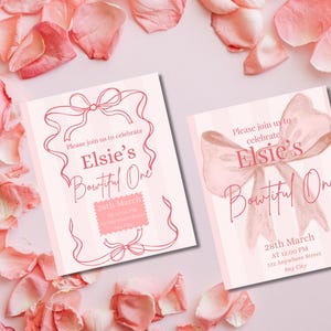 May include: Two pink and white invitations with the text "Elsie's Boutiful One" and event details. The invitations feature a bow design and are surrounded by pink rose petals. The text "Please join us to celebrate" is also included.
