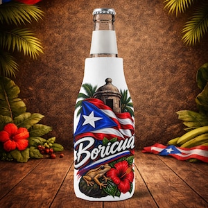May include: A white bottle cooler sleeve featuring a graphic print of the Puerto Rican flag, a stone sentry box, a small frog, and a red hibiscus flower. The word Boricua is printed in a bold white script font across the center of the design.