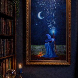 May include: A framed painting depicts a wizard in a blue robe and hat, conjuring fireworks under a crescent moon and stars. The artwork has a gold ornate frame and is illuminated by a small light above.