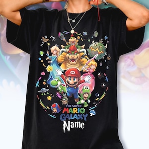 May include: A white ceramic mug with a black handle and the text "But First, Coffee" in a bold, black font. The mug is set against a neutral background, highlighting its simple design.